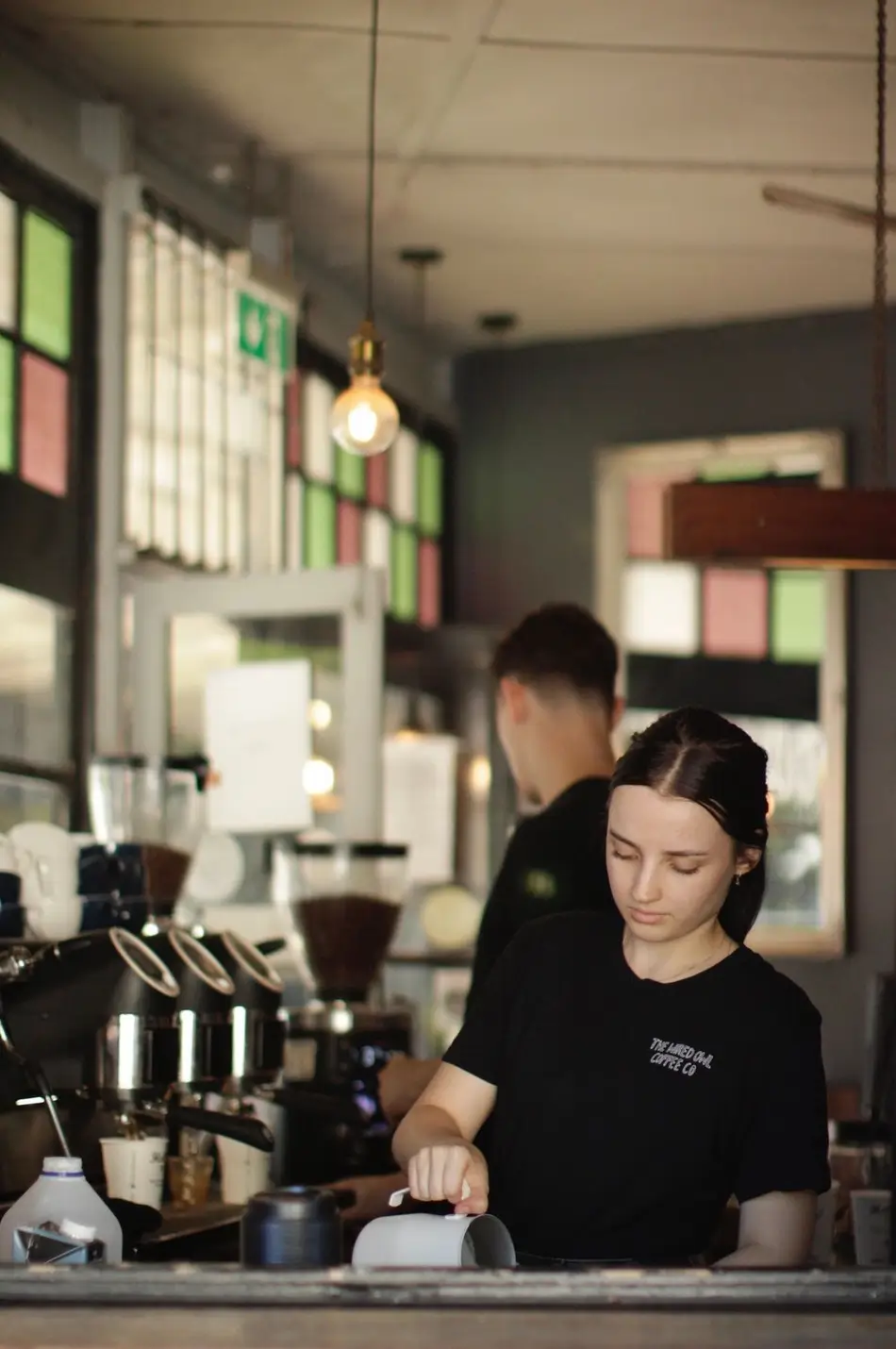 Staff member pouring a coffee